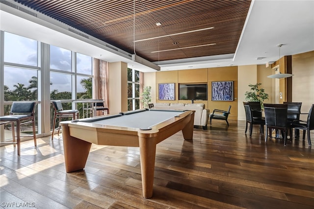 rec room featuring hardwood / wood-style flooring, wood ceiling, pool table, a tray ceiling, and a wall of windows