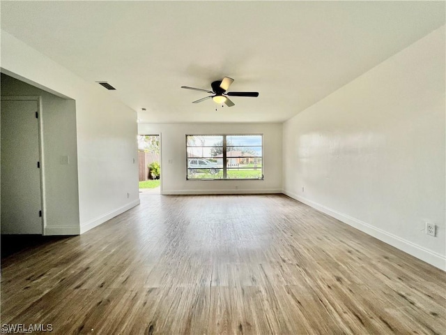 empty room featuring hardwood / wood-style flooring and ceiling fan