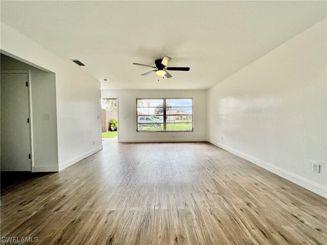 empty room featuring hardwood / wood-style flooring and ceiling fan