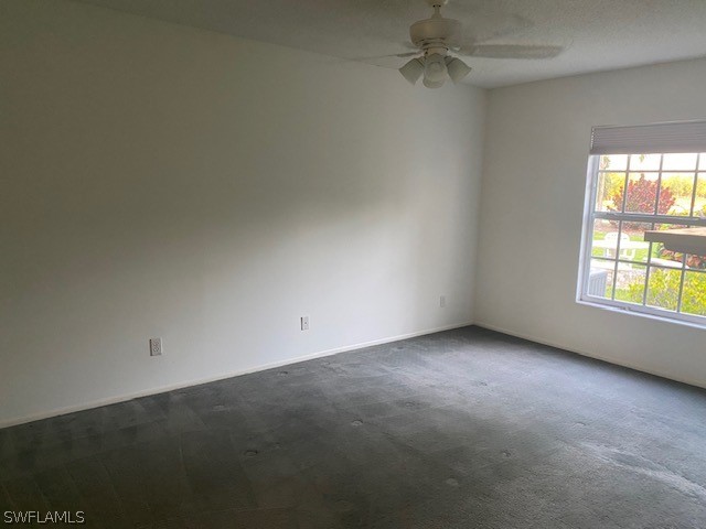 unfurnished room featuring carpet and ceiling fan