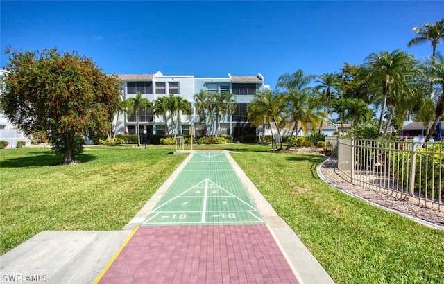 view of property's community with a lawn