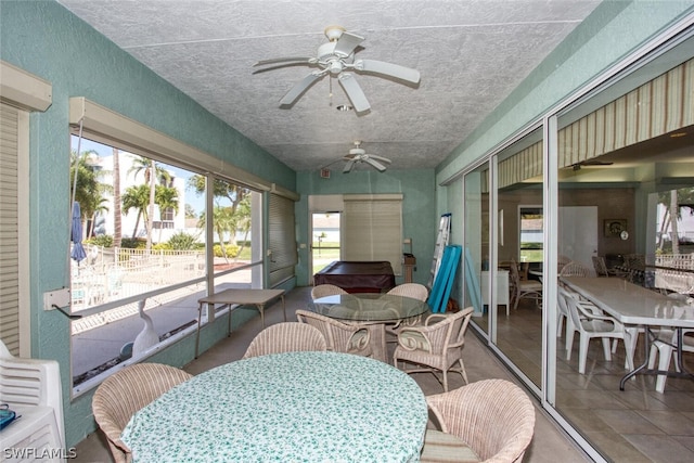 sunroom / solarium with ceiling fan and vaulted ceiling