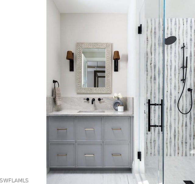 bathroom with vanity and a shower with shower door