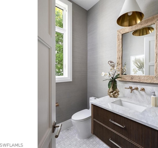 bathroom with tile patterned floors, vanity, toilet, and plenty of natural light