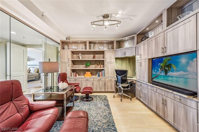 living room featuring light hardwood / wood-style floors and built in desk