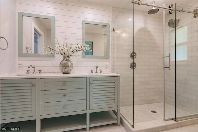 bathroom with walk in shower, tasteful backsplash, and dual bowl vanity