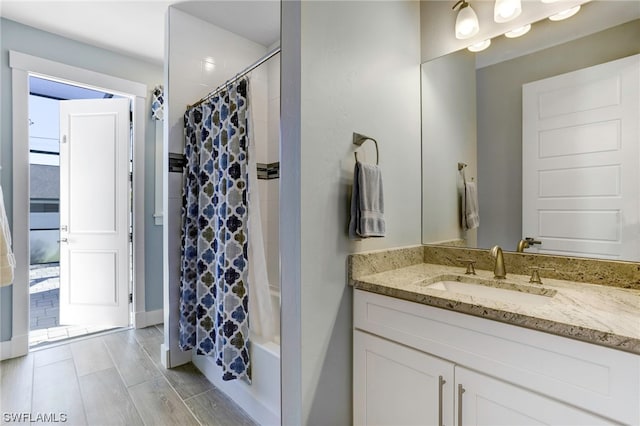 bathroom featuring vanity and shower / bath combo with shower curtain