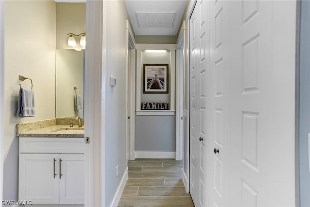 hallway featuring light hardwood / wood-style floors and sink