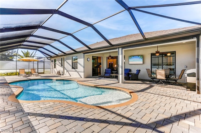 view of pool featuring a lanai, ceiling fan, and a patio