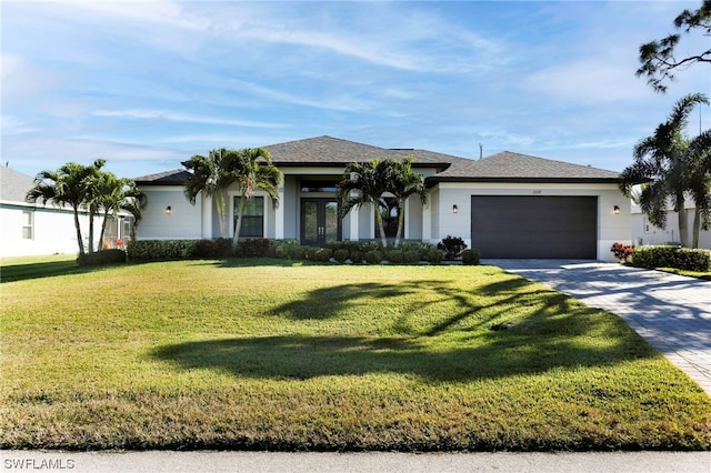 view of front of property featuring a front yard and a garage