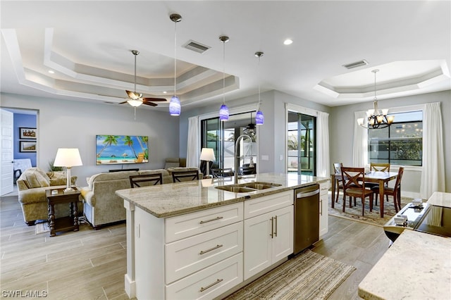 kitchen with a raised ceiling, sink, and dishwasher