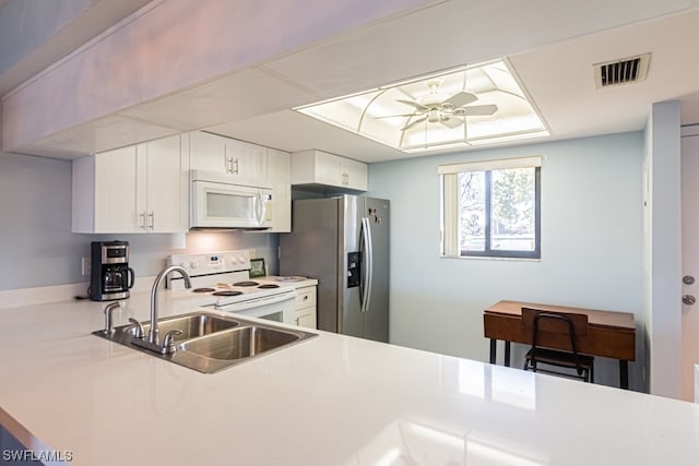 kitchen featuring white appliances, ceiling fan, sink, and white cabinetry