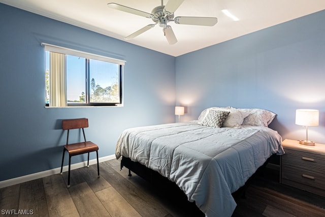 bedroom with dark hardwood / wood-style flooring and ceiling fan