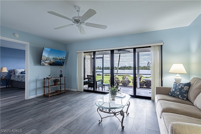 living room featuring dark hardwood / wood-style flooring and ceiling fan