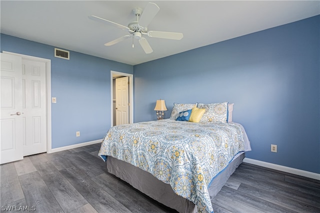 bedroom with a closet, ceiling fan, and dark hardwood / wood-style flooring