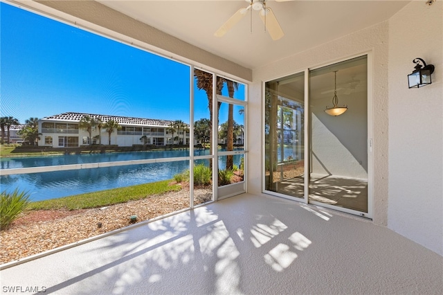 unfurnished sunroom with ceiling fan