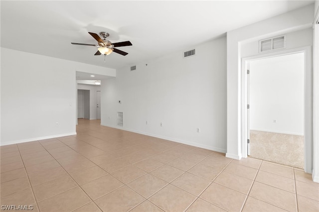 tiled spare room with ceiling fan