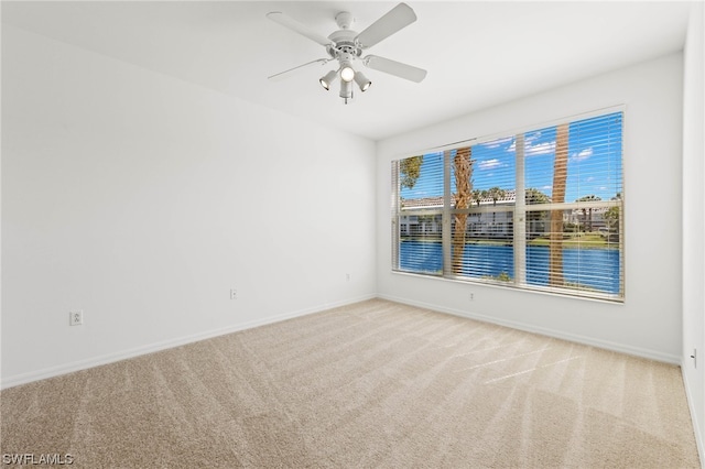 spare room with light carpet and ceiling fan