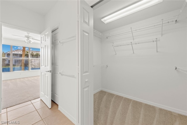 walk in closet featuring ceiling fan and light tile floors