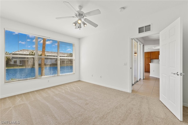 empty room with light carpet and ceiling fan