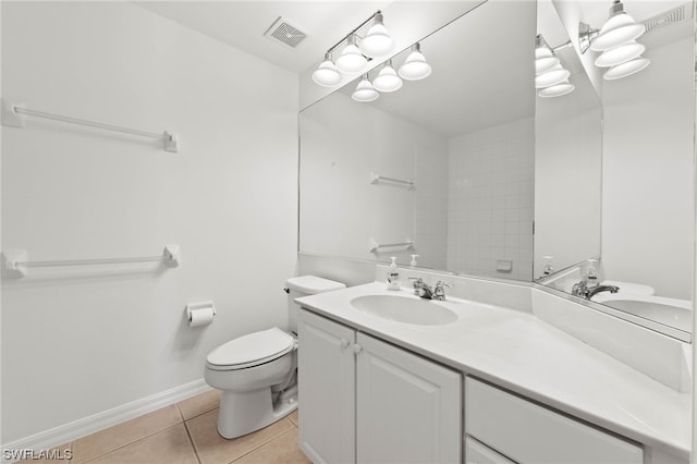 bathroom with toilet, large vanity, and tile flooring