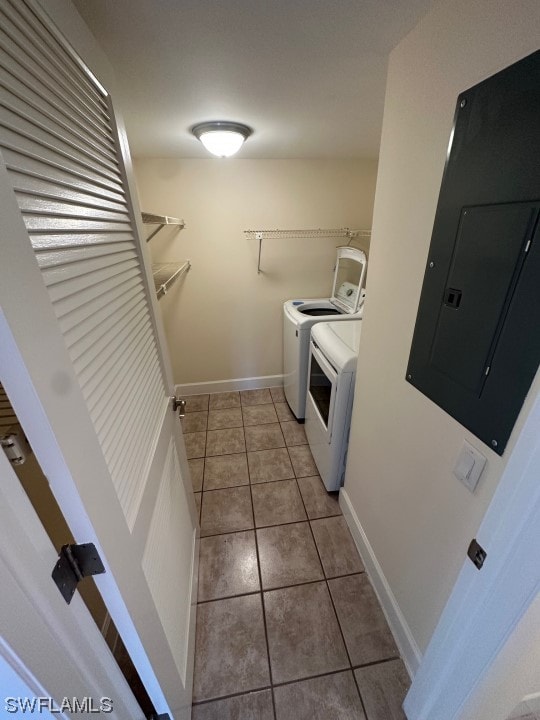 washroom with washer and dryer and light tile floors