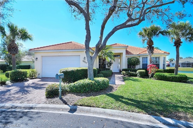 view of front of house with a front yard and a garage