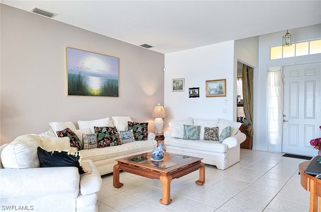 living room with light tile floors and a healthy amount of sunlight