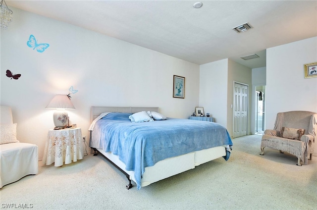 bedroom featuring a closet and light colored carpet