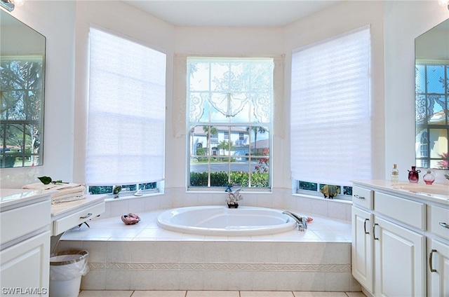 bathroom with vanity and tiled tub