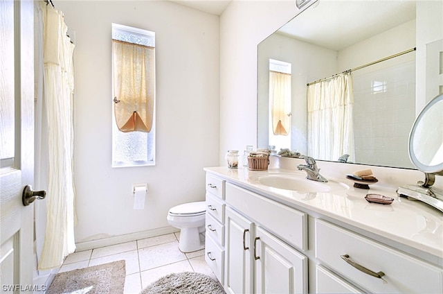 bathroom featuring toilet, large vanity, and tile floors