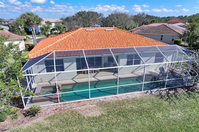 exterior space with a lawn and a lanai