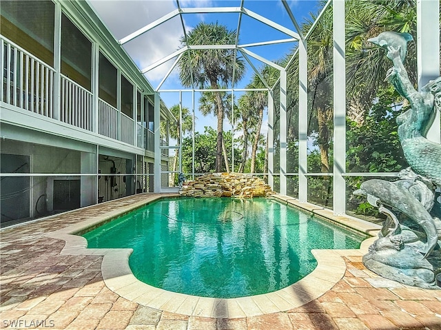 view of swimming pool with a lanai and a patio