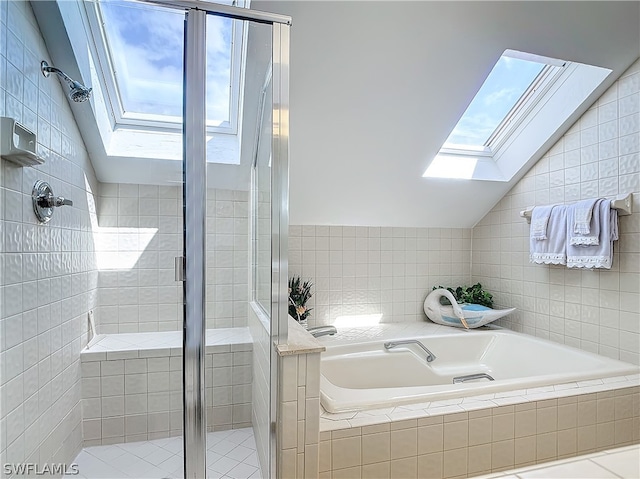 bathroom featuring plus walk in shower, lofted ceiling with skylight, and a healthy amount of sunlight