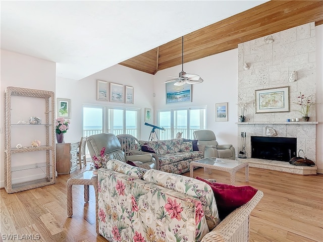 living room with wood ceiling, ceiling fan, a fireplace, and light hardwood / wood-style flooring