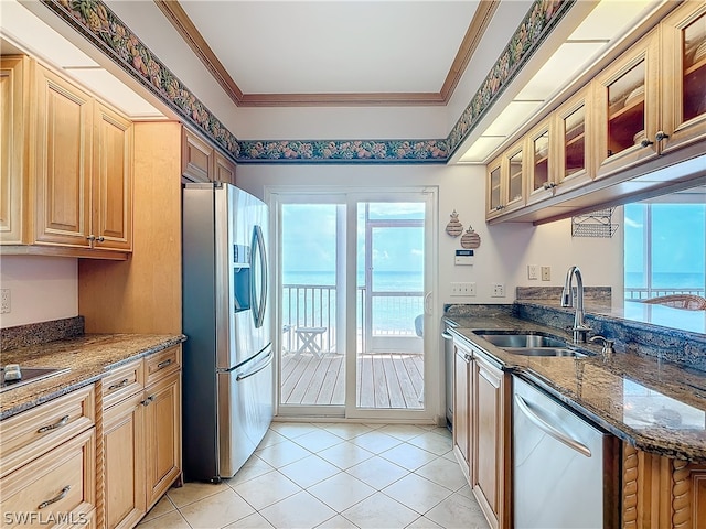 kitchen with ornamental molding, appliances with stainless steel finishes, light tile patterned floors, and sink