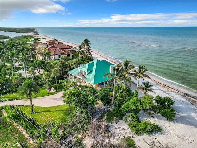 birds eye view of property with a water view and a view of the beach