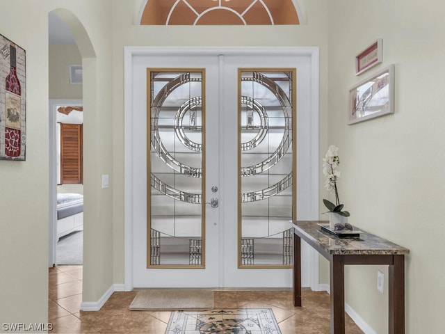 tiled entryway featuring french doors