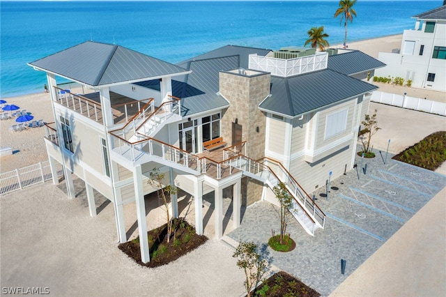 drone / aerial view featuring a beach view and a water view