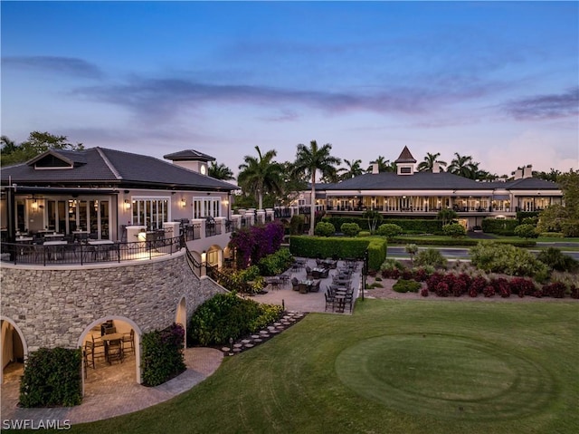 yard at dusk with a patio area