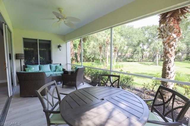 sunroom featuring ceiling fan