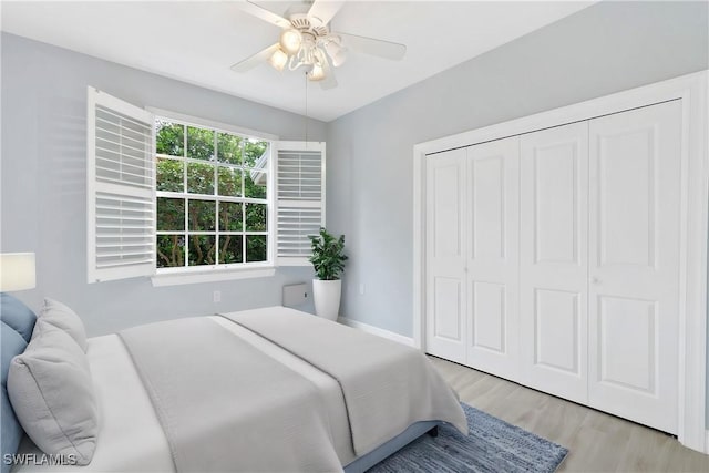 bedroom with a closet, ceiling fan, and light hardwood / wood-style flooring