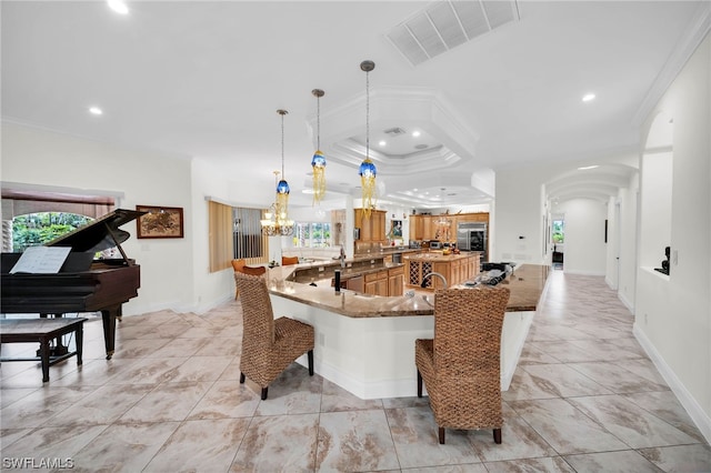 interior space with a healthy amount of sunlight, light tile flooring, and ornamental molding