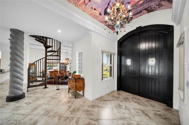 tiled foyer featuring crown molding and a chandelier