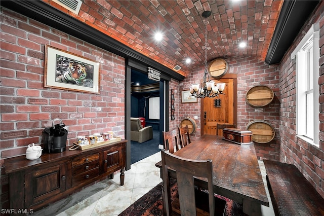 tiled dining area featuring brick wall and an inviting chandelier