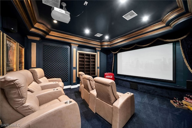 cinema featuring dark colored carpet, a tray ceiling, and ornamental molding