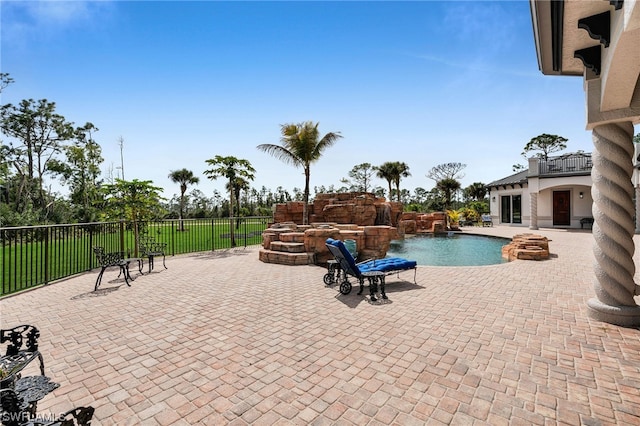 view of pool with a patio area and pool water feature