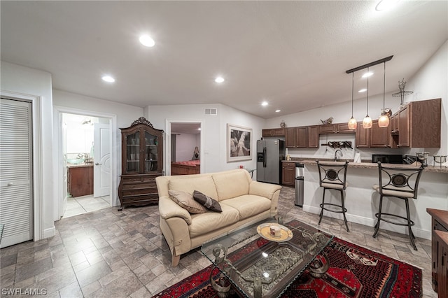 living room featuring light tile flooring and sink