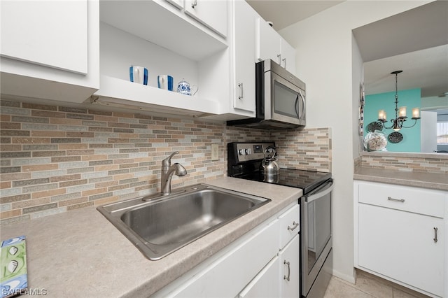 kitchen with white cabinetry, tasteful backsplash, a notable chandelier, and appliances with stainless steel finishes