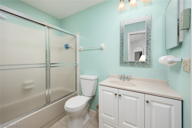 full bathroom featuring tile floors, oversized vanity, toilet, and bath / shower combo with glass door